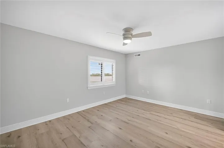 Spare room featuring light plank tile floors and a ceiling fan