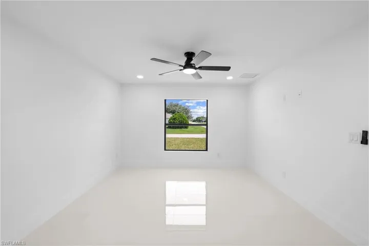 Empty room featuring recessed lighting and a ceiling fan