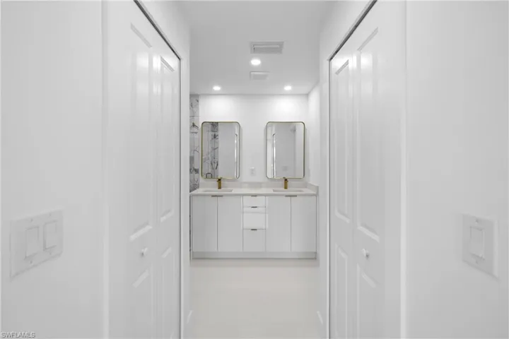 Corridor with recessed lighting and a sink