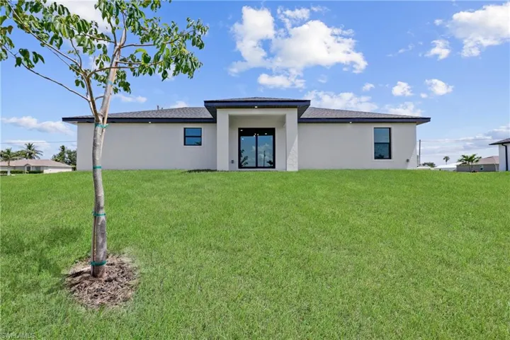 View of grassy yard with a water view