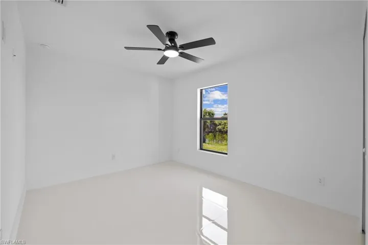 Unfurnished room featuring ceiling fan