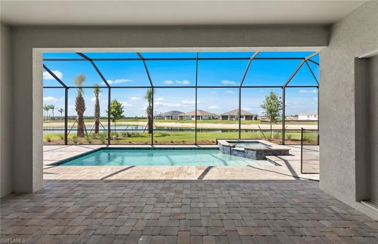 View of swimming pool featuring a patio area, a lanai, and an in ground hot tub