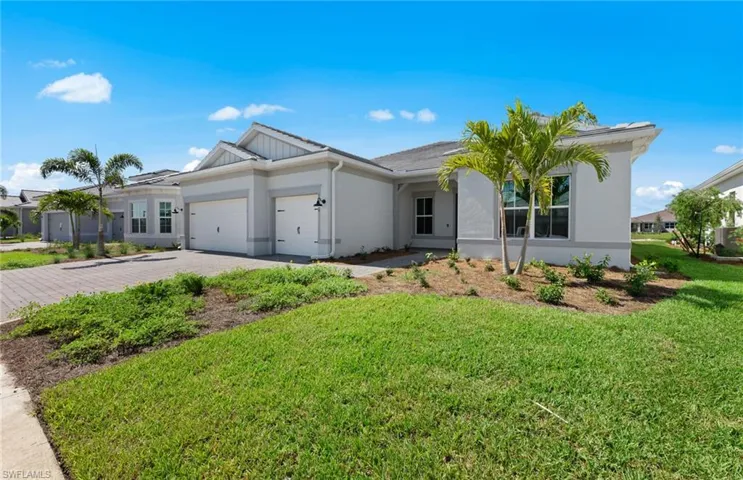 Single story home with a garage and a front lawn
