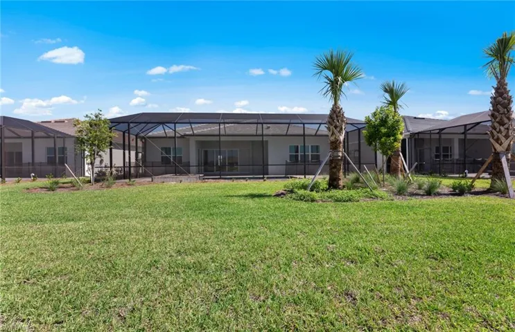 View of yard featuring glass enclosure