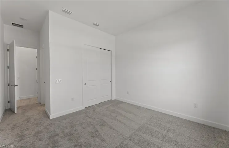 Unfurnished bedroom with a closet and carpet