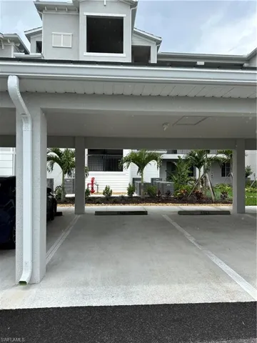 View of vehicle parking featuring a carport