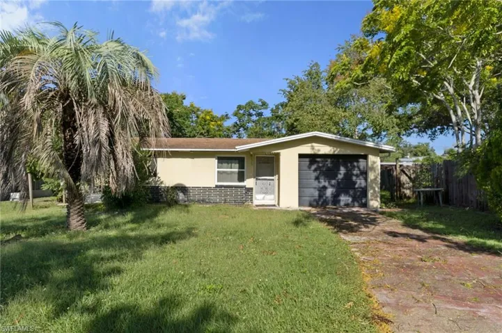 View of front of property with a front lawn and a garage