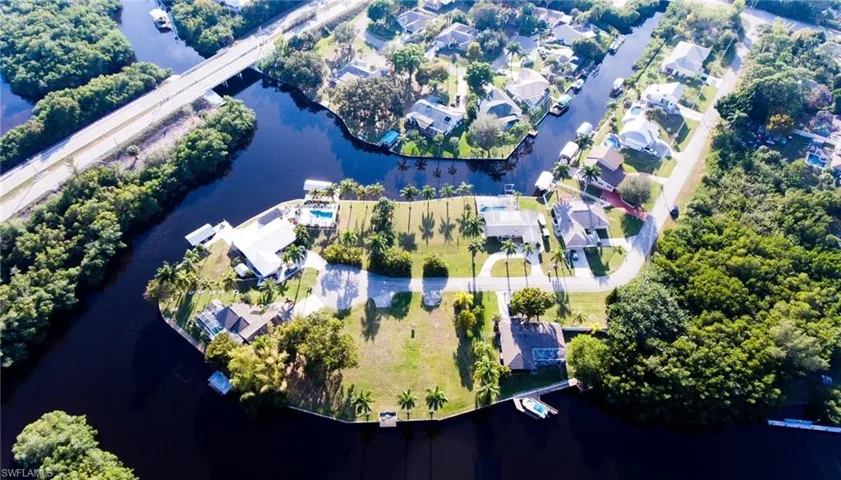 Aerial photo of home (top) and street, on Gulf access canal