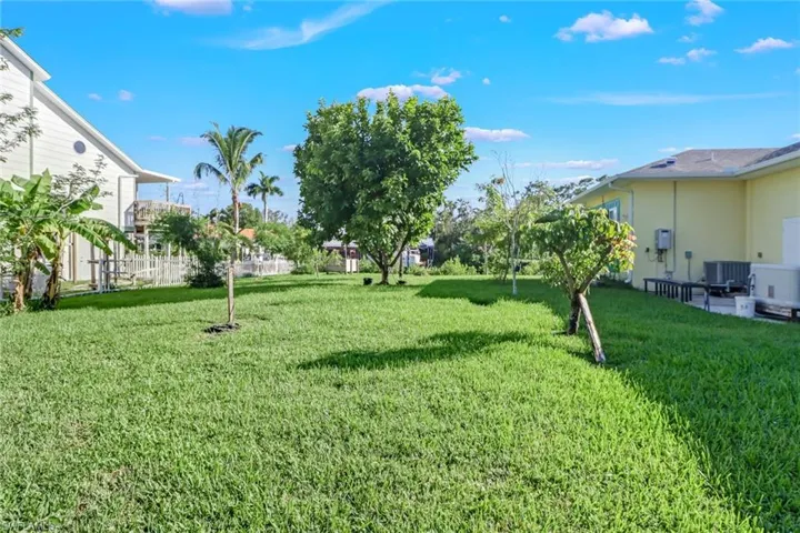 View of yard with central air condition unit, generator, water heater,