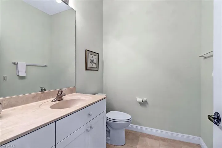 Bathroom #3 featuring vanity, toilet, and tile patterned flooring