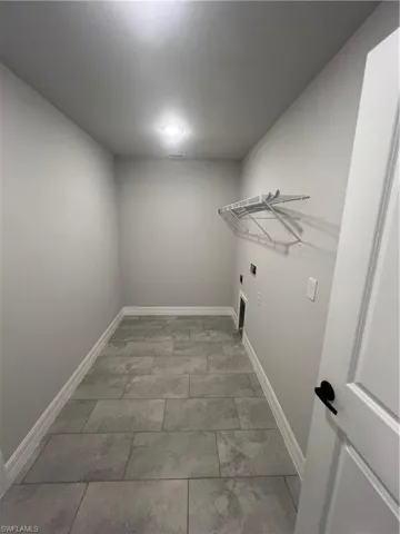 Washroom featuring hookup for an electric dryer