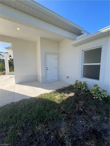 Property entrance featuring a patio