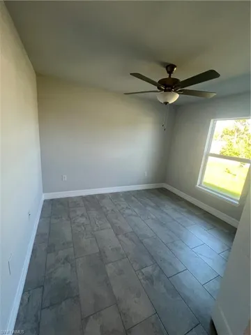 Unfurnished room featuring ceiling fan