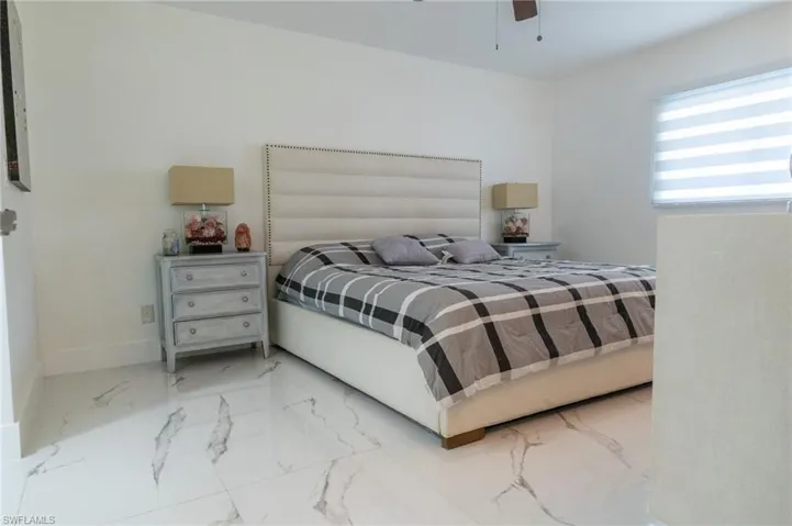 Bedroom featuring porcelain finish floors and ceiling fan