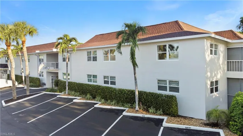 View of property featuring uncovered parking