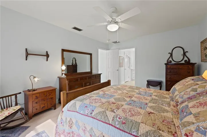 Carpeted bedroom featuring ceiling fan