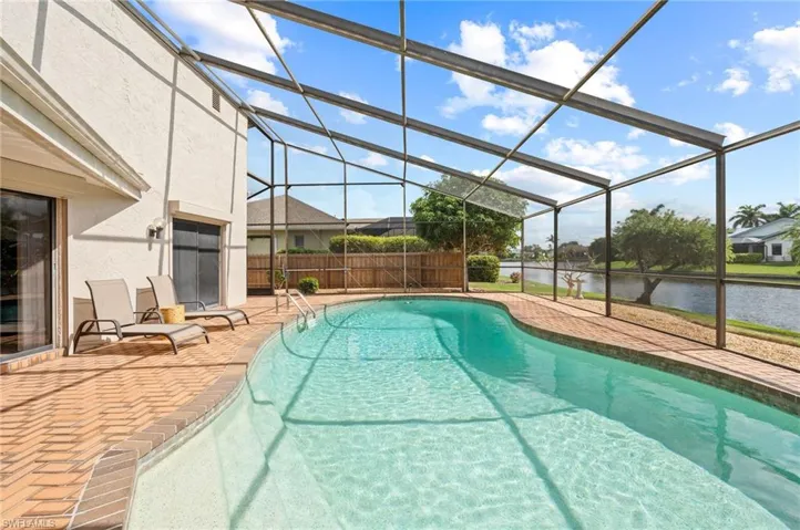 View of pool with a water view, a lanai, and a patio