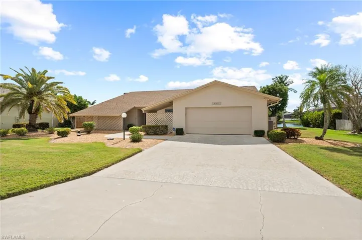 View of front of home with a garage and a front yard