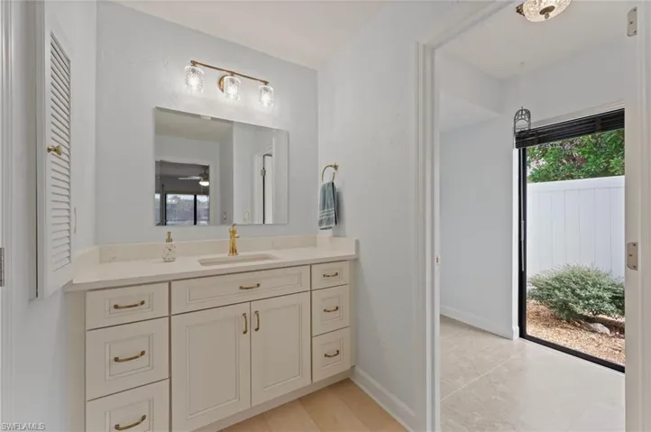 Bathroom with vanity and ceiling fan