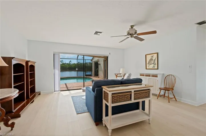 Bedroom featuring ceiling fan, access to exterior, and light hardwood / wood-style flooring