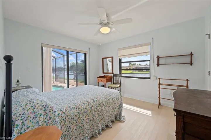 Bedroom with access to exterior, ceiling fan, and light hardwood / wood-style flooring
