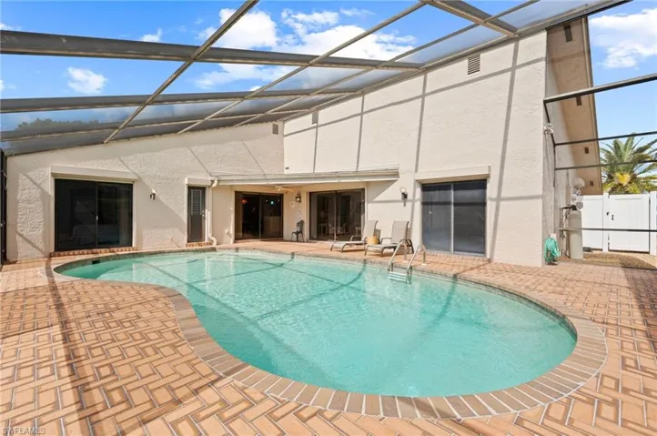 View of pool with a lanai and a patio area
