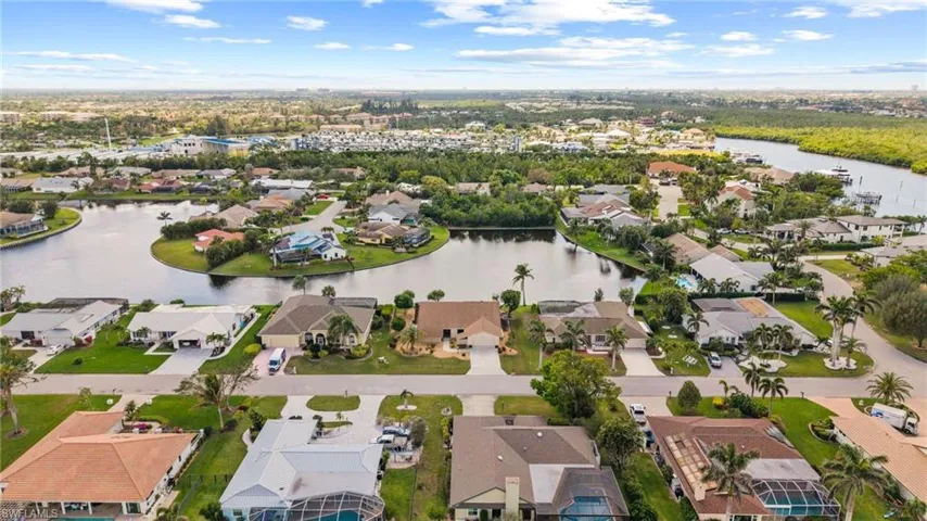 Birds eye view of property with a water view