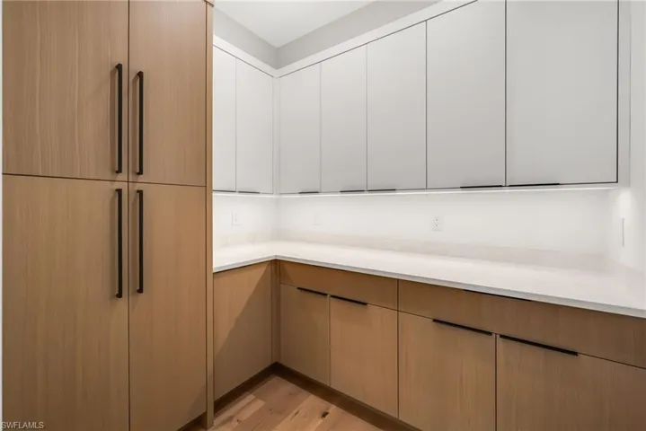Walk-in pantry featuring additional custom cabinetry for elevated storage and organization.