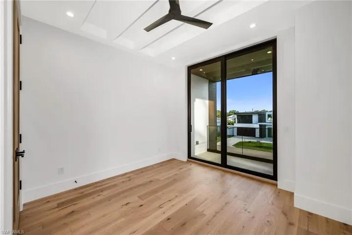 Guest Bedroom 1 with a private ensuite bath and balcony.