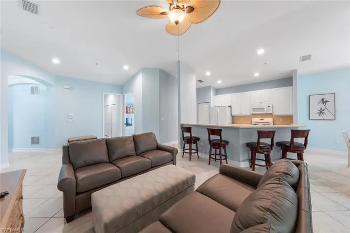 Tiled living room featuring ceiling fan