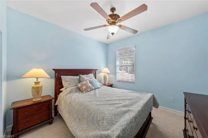 Bedroom with light carpet and ceiling fan