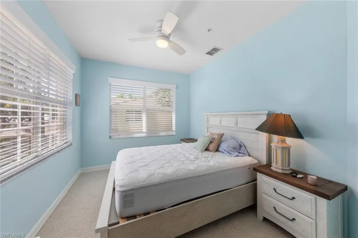 Bedroom with light carpet and ceiling fan