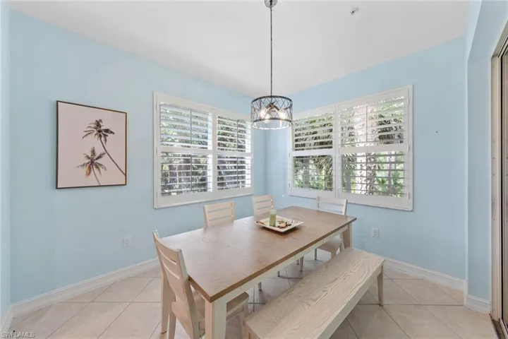 Tiled dining space with an inviting chandelier