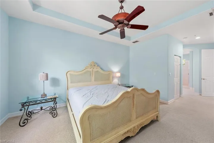 Bedroom with light colored carpet and ceiling fan