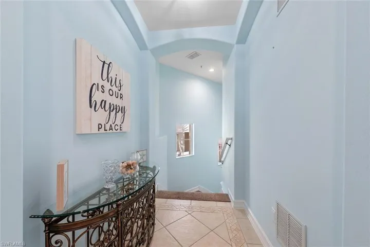 Hall featuring light tile patterned flooring