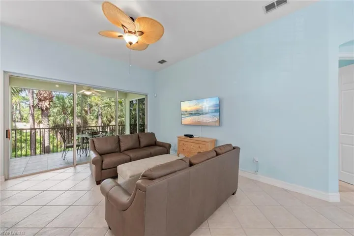 Living room featuring ceiling fan and light tile patterned floors