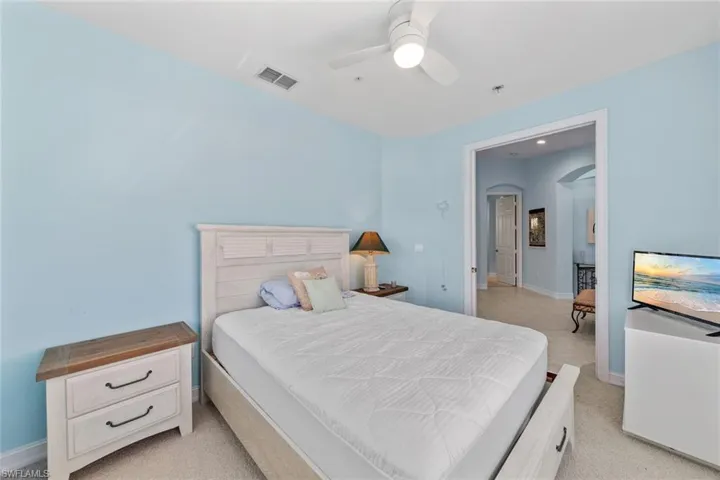 Carpeted bedroom with ceiling fan