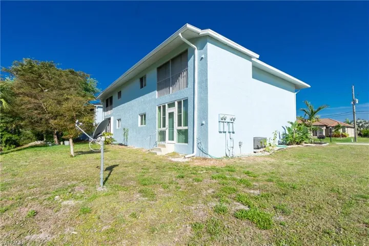 View of side of property featuring a yard
