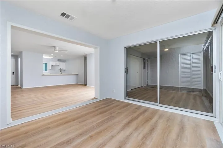 Empty room with ceiling fan and light hardwood / wood-style floors
