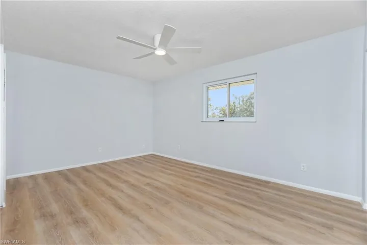 Empty room featuring ceiling fan and light wood-type flooring