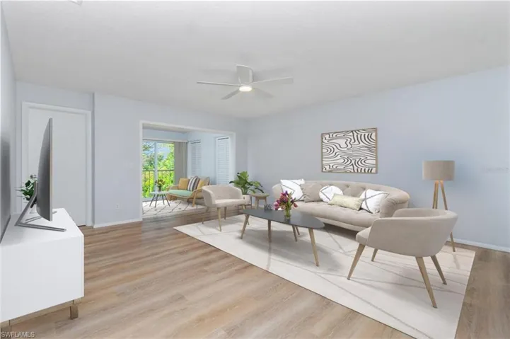 Living room featuring ceiling fan and light hardwood / wood-style floors