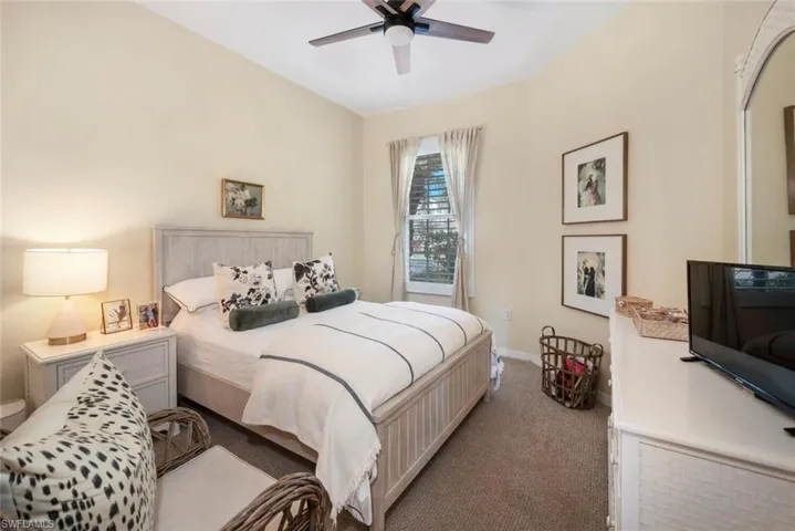 Carpeted bedroom with ceiling fan