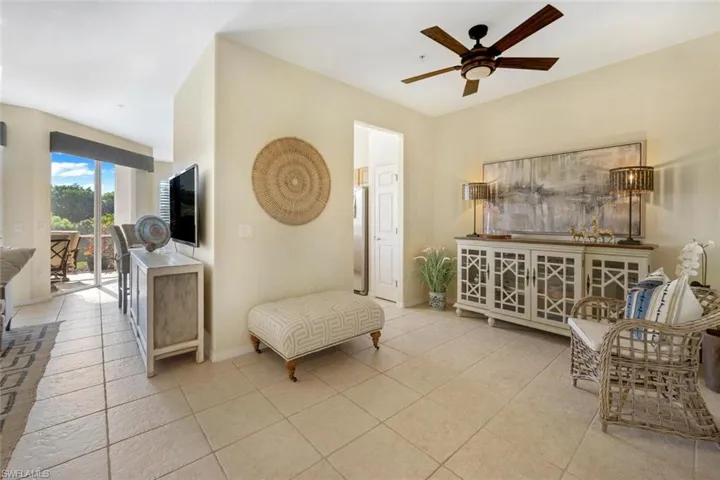 Living area with ceiling fan and light tile floors