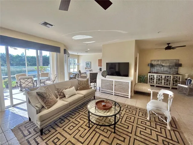 Living room with light tile flooring and ceiling fan