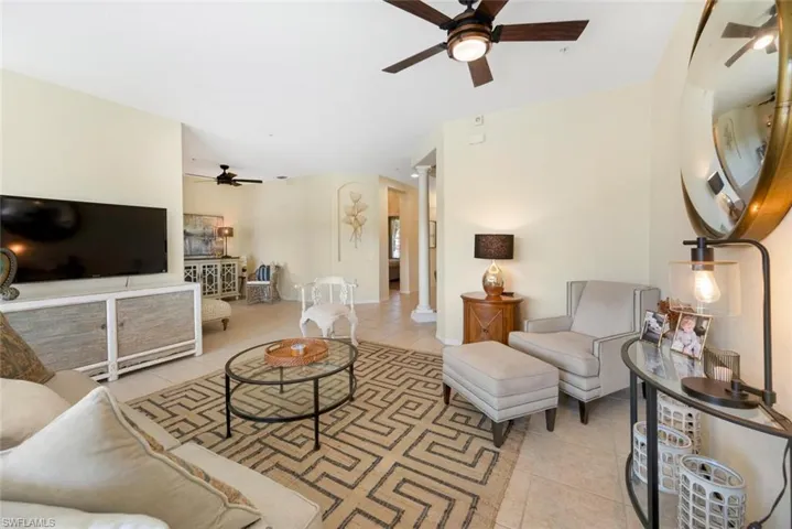 Tiled living room featuring ceiling fan