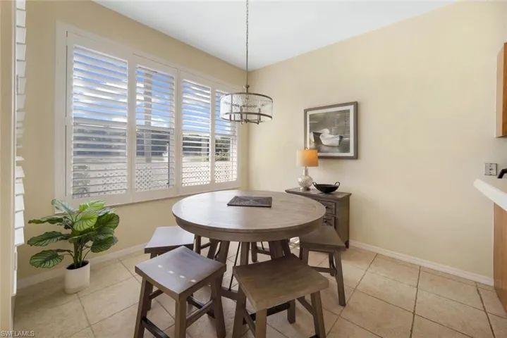 Dining room featuring a notable chandelier and light tile flooring