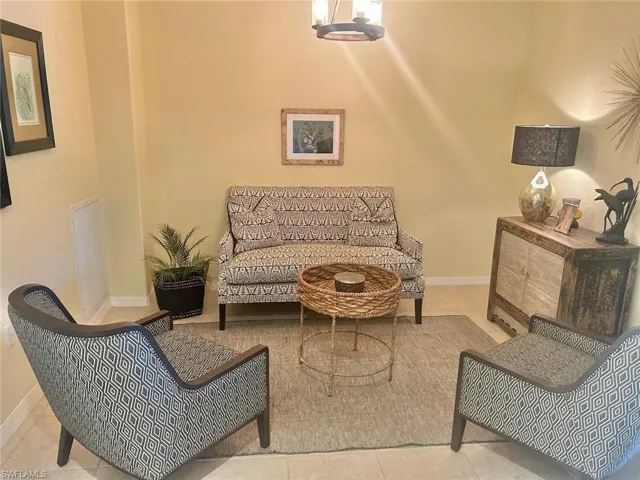 Living area featuring an inviting chandelier and tile floors