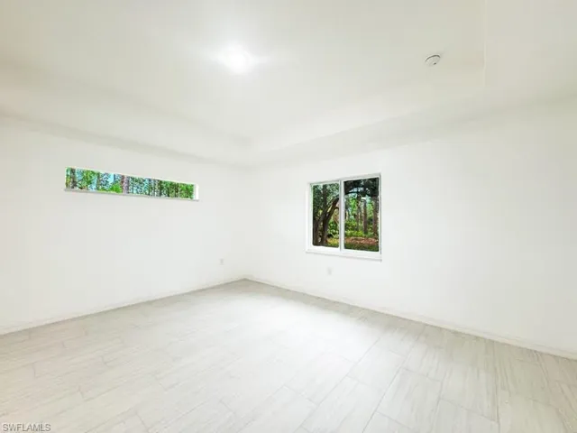 Empty room featuring a tray ceiling