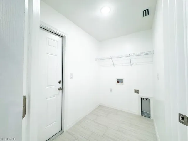 Washroom with hookup for a washing machine and electric dryer hookup