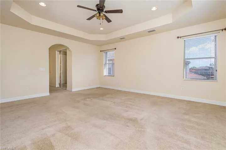 Overall of the primary bedroom, can see plenty of natural light.